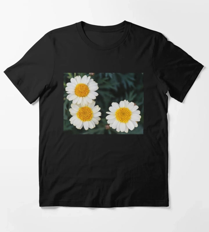 Three White Daisies With Bright Yellow Centers CloseUp On Dark Green Foliage Background T-Shirt